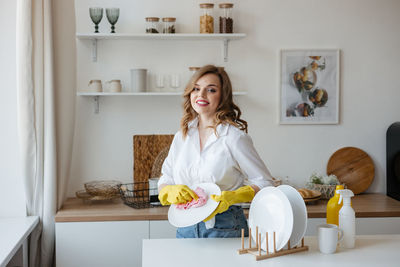 Portrait of young woman sitting at home