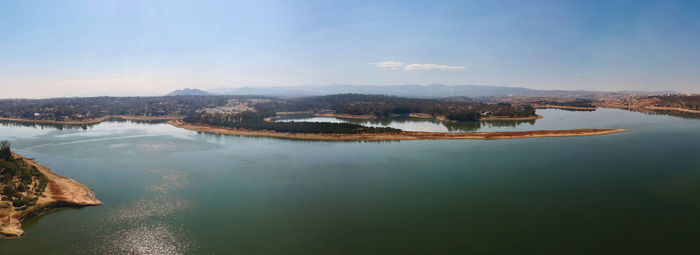Scenic view of lake by mountain against sky
