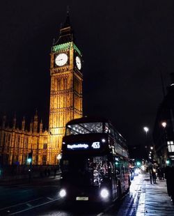 Illuminated clock tower at night