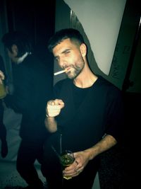 Portrait of young woman holding smart phone