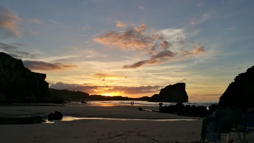 Scenic view of beach against sky during sunset