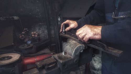 Midsection of man working in workshop