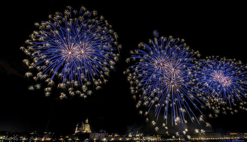 Low angle view of firework display at night