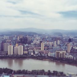 Cityscape against cloudy sky