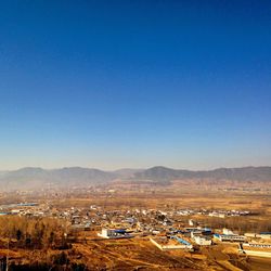 High angle shot of townscape against clear blue sky