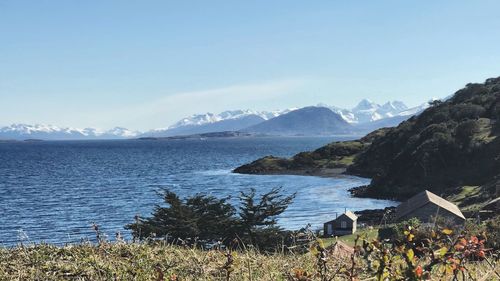 Scenic view of sea and mountains against sky