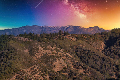 Scenic view of mountains against sky at night