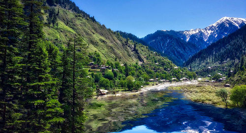 Scenic view of mountains against blue sky