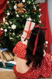 Portrait of woman holding a present on christmas day 