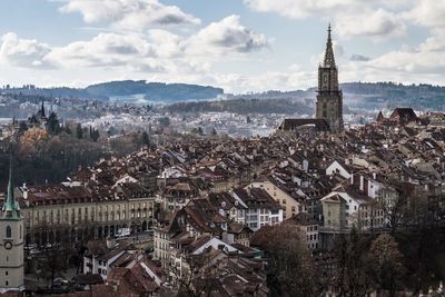 View of cityscape against cloudy sky