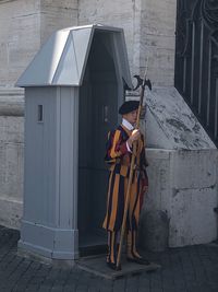 Woman standing by building