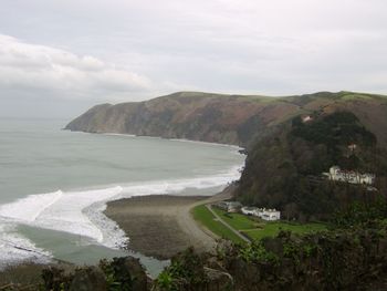 Scenic view of sea and mountains against sky