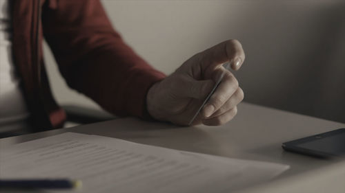 Midsection of businessman working on table