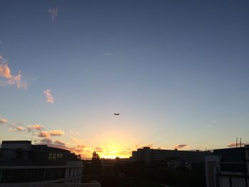 Low angle view of city against sky during sunset