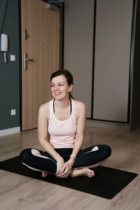 Portrait of smiling hapyy woman doing sport exercises at home