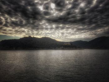 Scenic view of mountains against cloudy sky