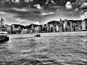 Buildings against cloudy sky