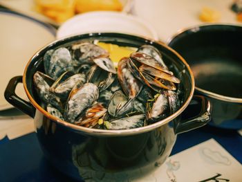 High angle view of mussels in pot on table
