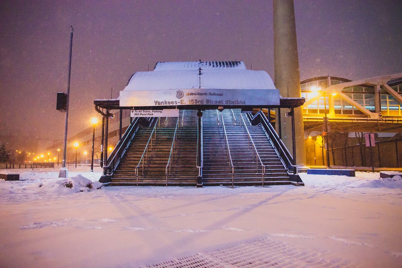 SNOW COVERED ILLUMINATED CITY AT NIGHT