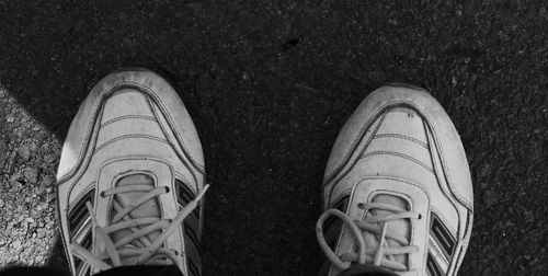 Low section of man standing on tiled floor