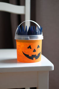 Jack o' lantern trick or treat bucket from reused cookie bucket