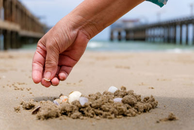 Close-up of hand holding sand