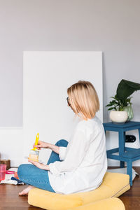 Woman sitting on table at home