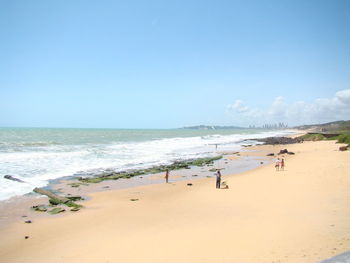 Scenic view of beach against blue sky