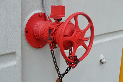 Close-up of red chain against wall