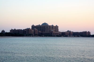 Buildings in city at sunset