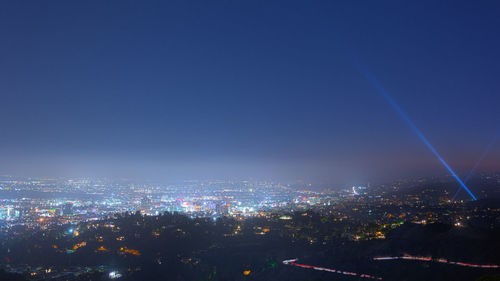 High angle view of illuminated buildings against sky at night