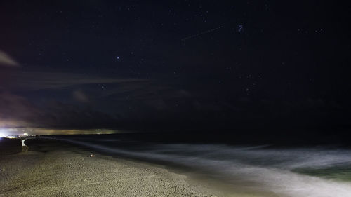 Scenic view of sea against sky at night