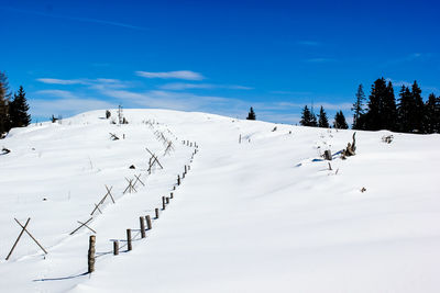 Scenic view of ski lift against sky during winter