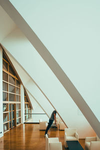 Side view of woman on staircase against building