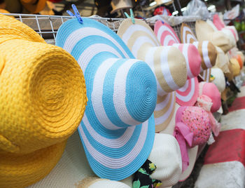 Close-up of various hat for sale at market stall