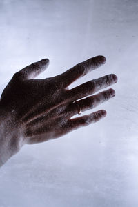High angle view of human hand over white background