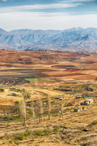 Scenic view of field and mountains against sky