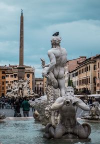 Statue of fountain against building