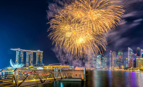 Firework display in city at night