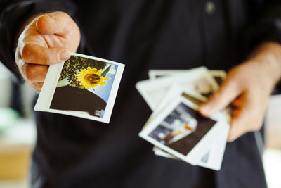 Midsection of man holding instant print transfers