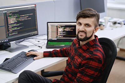 Portrait of young man working in office