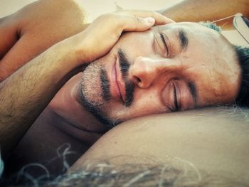 Close-up of man sleeping outdoors