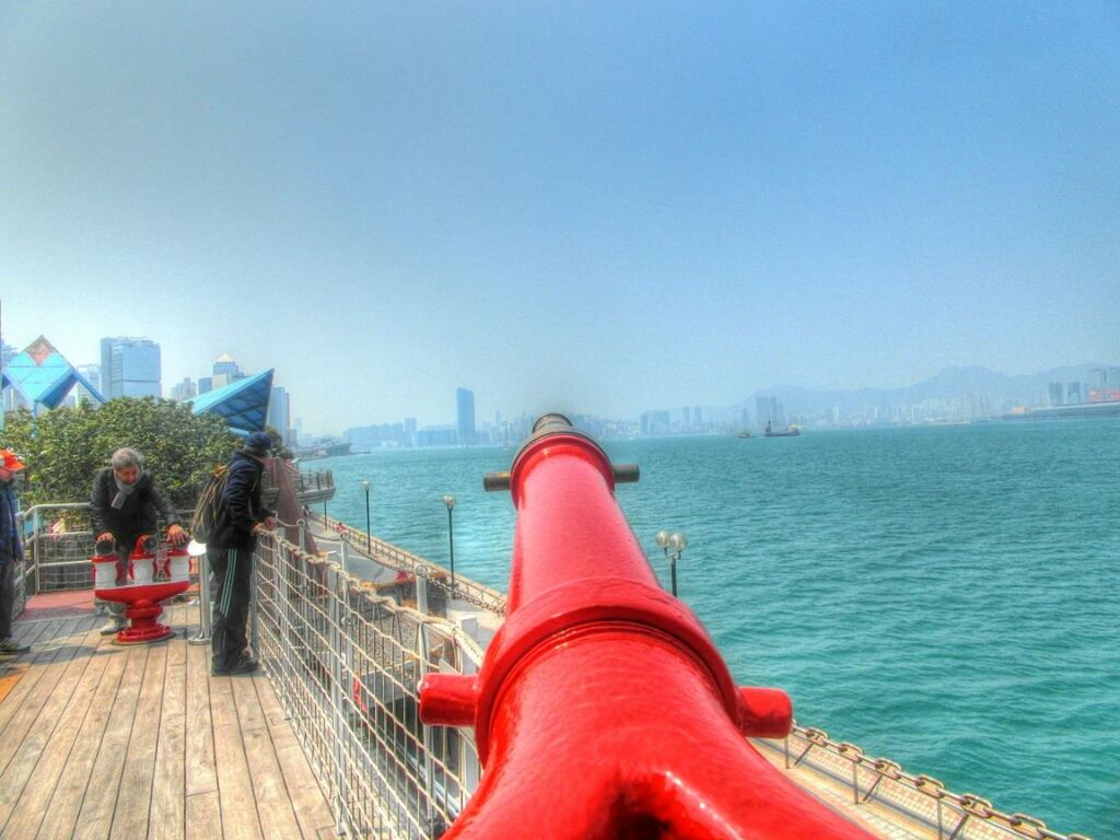 clear sky, copy space, built structure, architecture, water, blue, building exterior, railing, river, city, bridge - man made structure, travel destinations, connection, day, outdoors, travel, pier, lifestyles