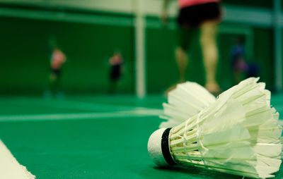 Close-up of shuttlecocks on sports court