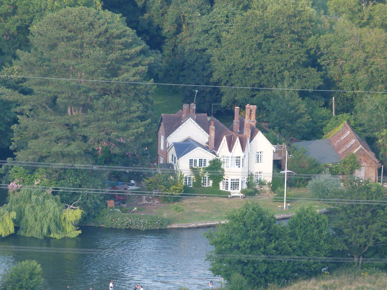 HOUSES BY RIVER AND TREES IN FOREST