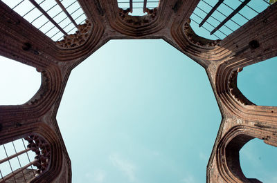 Directly below shot of old ruin against blue sky