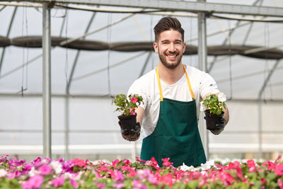 Young man working in greenhouse