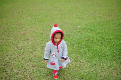 Cute boy standing in grass