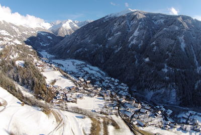 Scenic view of snow covered mountains against sky