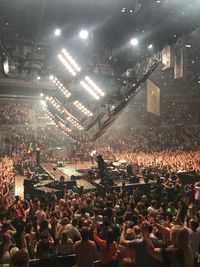 Crowd at music concert in city at night